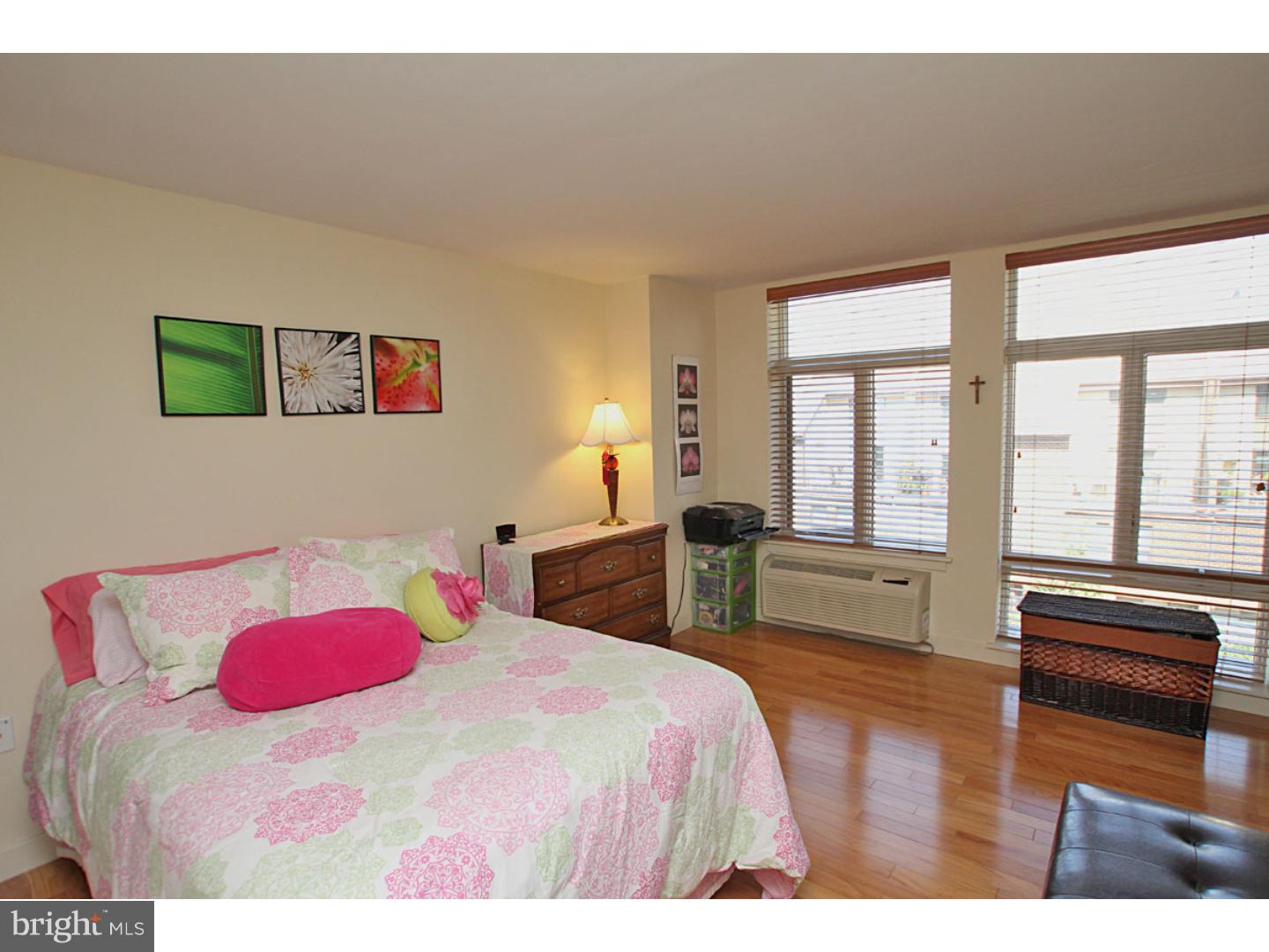 1900 Hamilton Street, Unit D19 Philadelphia, PA 19130 - Photo 21 of 25 a bedroom with a bed and wooden floor