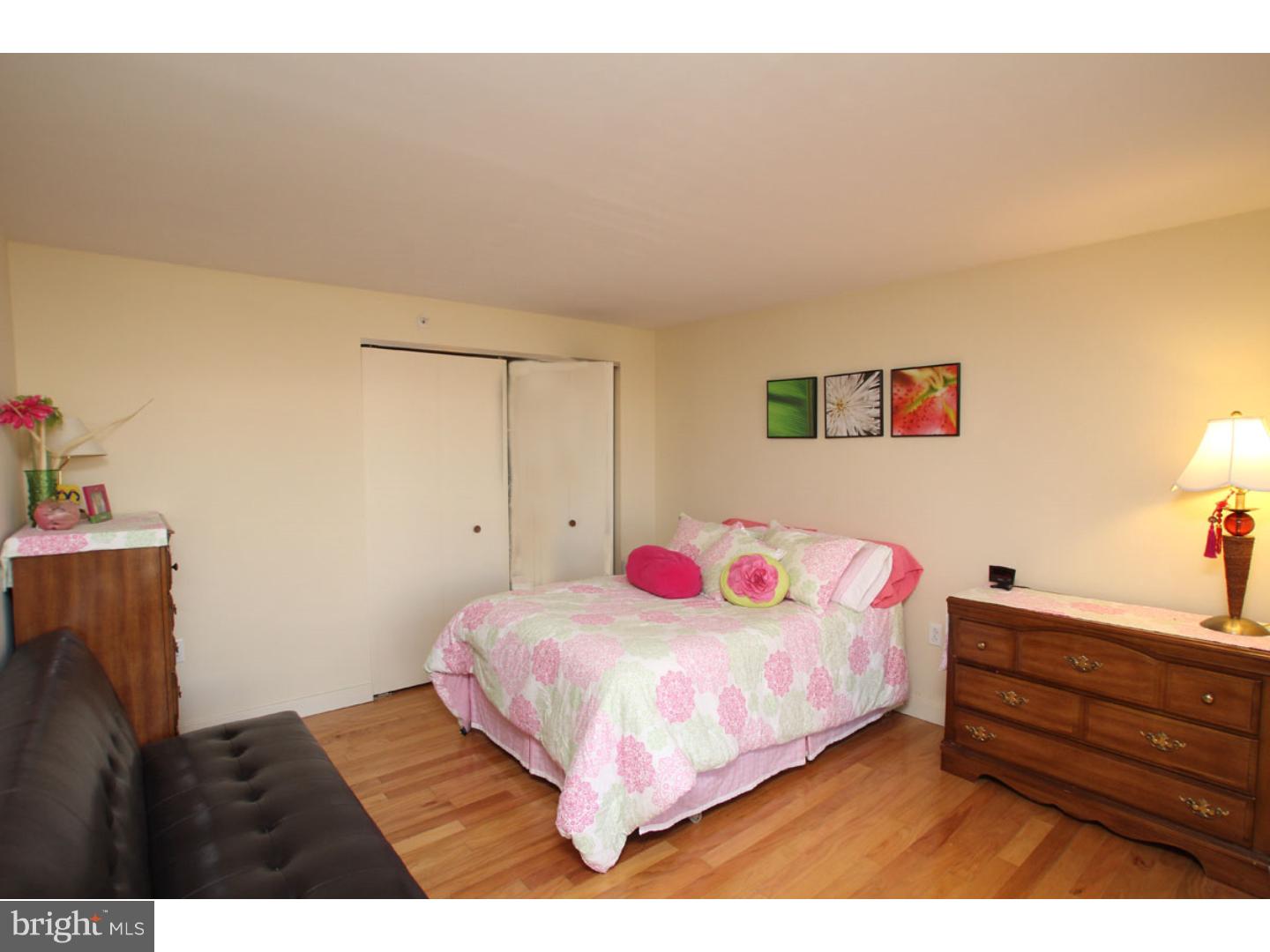 1900 Hamilton Street, Unit D19 Philadelphia, PA 19130 - Photo 22 of 25 a bedroom with a bed and a dresser