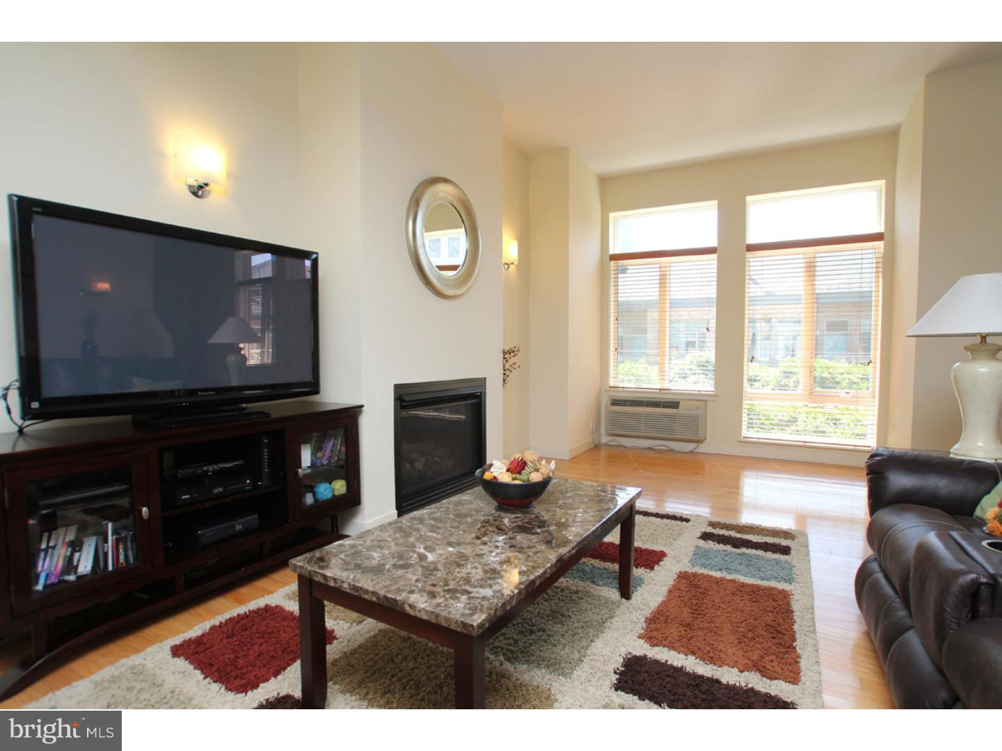 1900 Hamilton Street, Unit D19 Philadelphia, PA 19130 - Photo 4 of 25 a living room with furniture and a flat screen tv