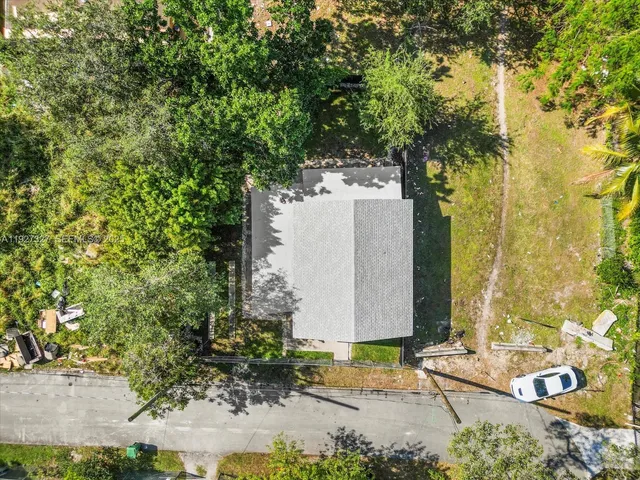 an aerial view of a house with a yard