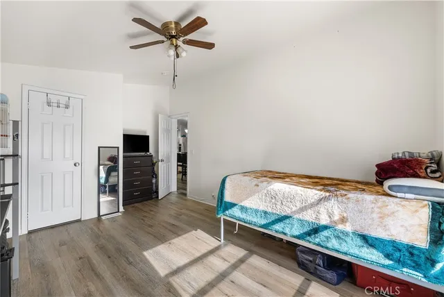 a bedroom with furniture and a flat screen tv