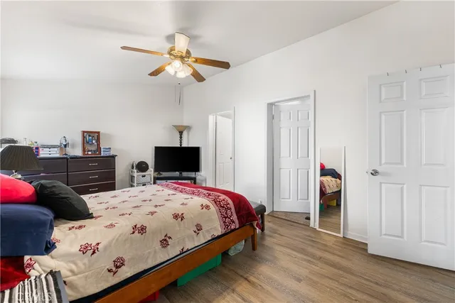 a bedroom with a bed and wooden floor