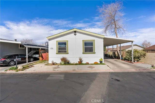 a view of a house with backyard and a garage