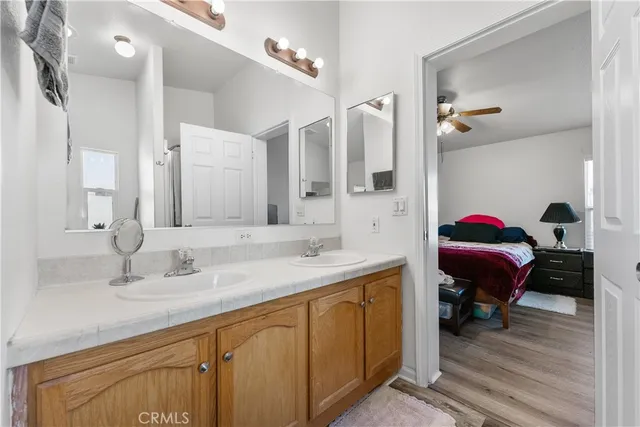 a en suite bathroom with a double vanity sink and a mirror