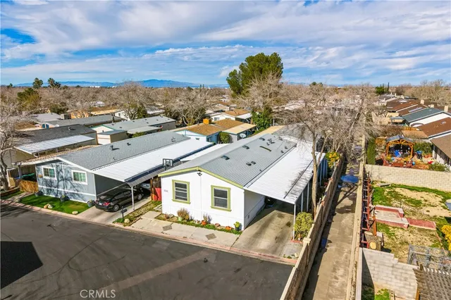 an aerial view of a house with a mountain