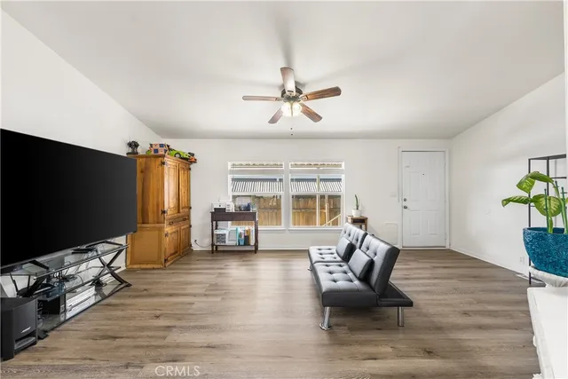 a living room with furniture windows and a flat screen tv