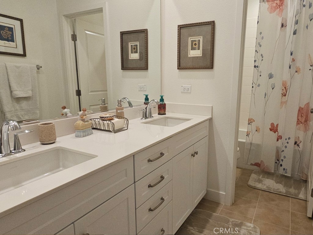 13952 Lily Lane Riverside, CA 92503 - Photo 22 of 42 a bathroom with double sink and a mirror