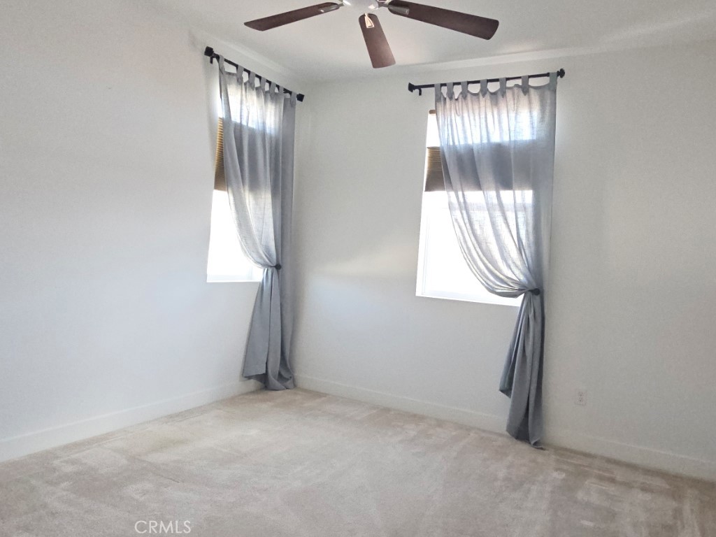 13952 Lily Lane Riverside, CA 92503 - Photo 25 of 42 an empty room with windows and closet