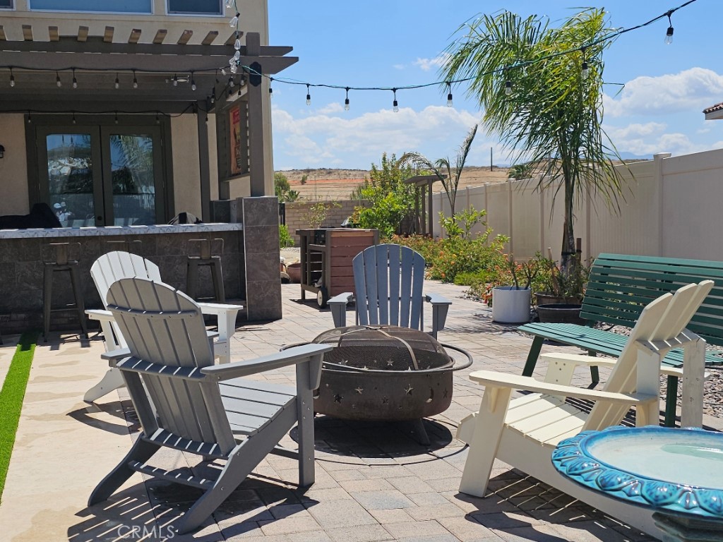 13952 Lily Lane Riverside, CA 92503 - Photo 30 of 42 a view of a patio with table and chairs potted plants and palm tree