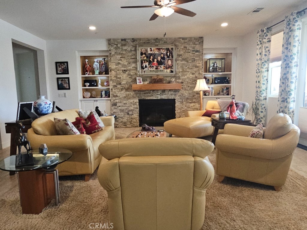 13952 Lily Lane Riverside, CA 92503 - Photo 6 of 42 a living room with furniture a fireplace and a chandelier
