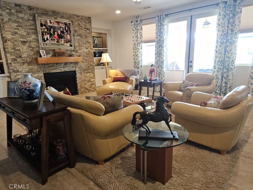 13952 Lily Lane Riverside, CA 92503 - Photo 8 of 42 a living room with furniture a large window and a fireplace