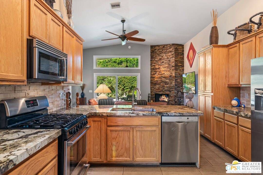 67860 Ontina Road Cathedral City, CA 92234 - Photo 12 of 48 a kitchen with stainless steel appliances a stove sink and microwave
