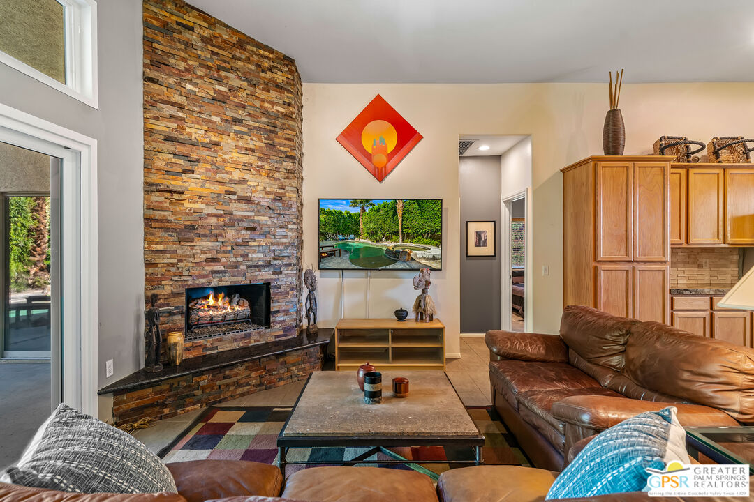 67860 Ontina Road Cathedral City, CA 92234 - Photo 15 of 48 a living room with furniture a rug and a fireplace