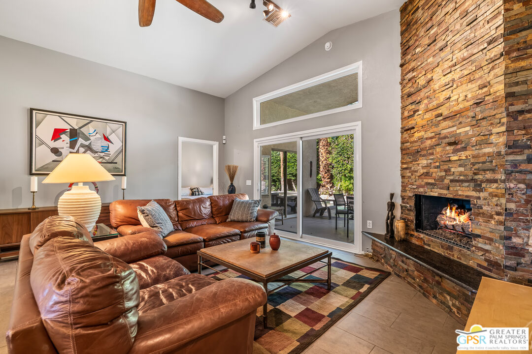 67860 Ontina Road Cathedral City, CA 92234 - Photo 18 of 48 a living room with furniture a flat screen tv and a fireplace