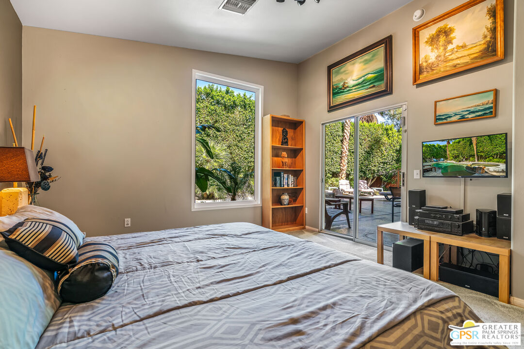 67860 Ontina Road Cathedral City, CA 92234 - Photo 20 of 48 a bedroom with a bed and wooden floor