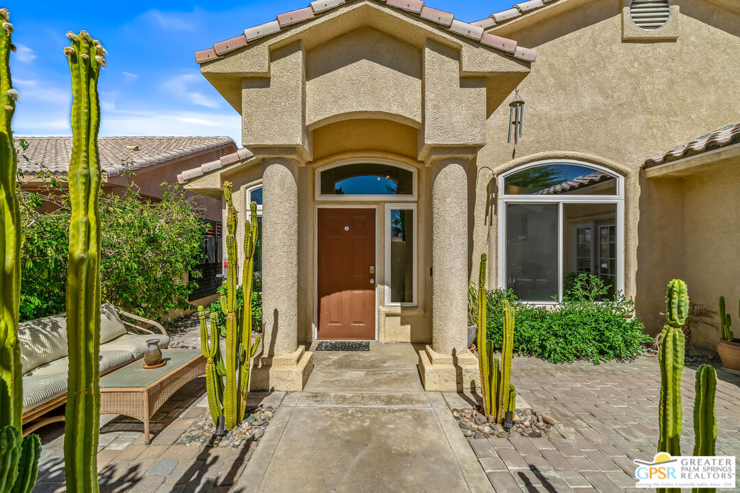 67860 Ontina Road Cathedral City, CA 92234 - Photo 2 of 48 a view of a brick house with large windows