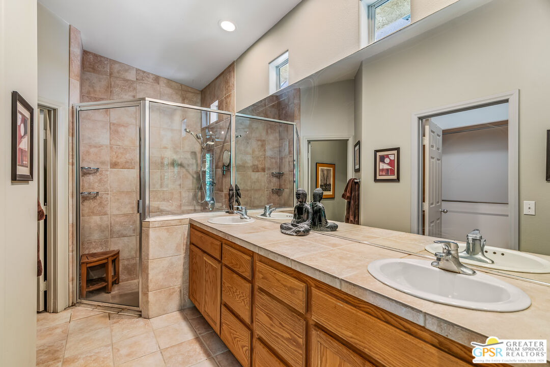 67860 Ontina Road Cathedral City, CA 92234 - Photo 22 of 48 a bathroom with a double vanity sink mirror and shower