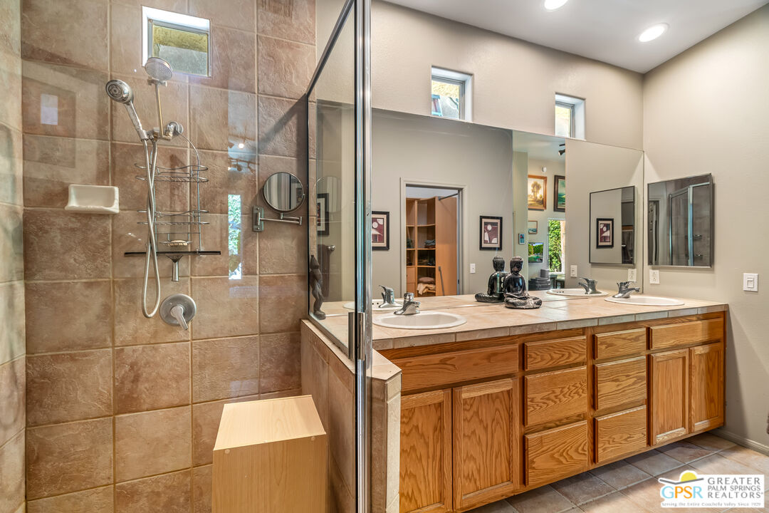 67860 Ontina Road Cathedral City, CA 92234 - Photo 23 of 48 a bathroom with a double vanity sink mirror and shower