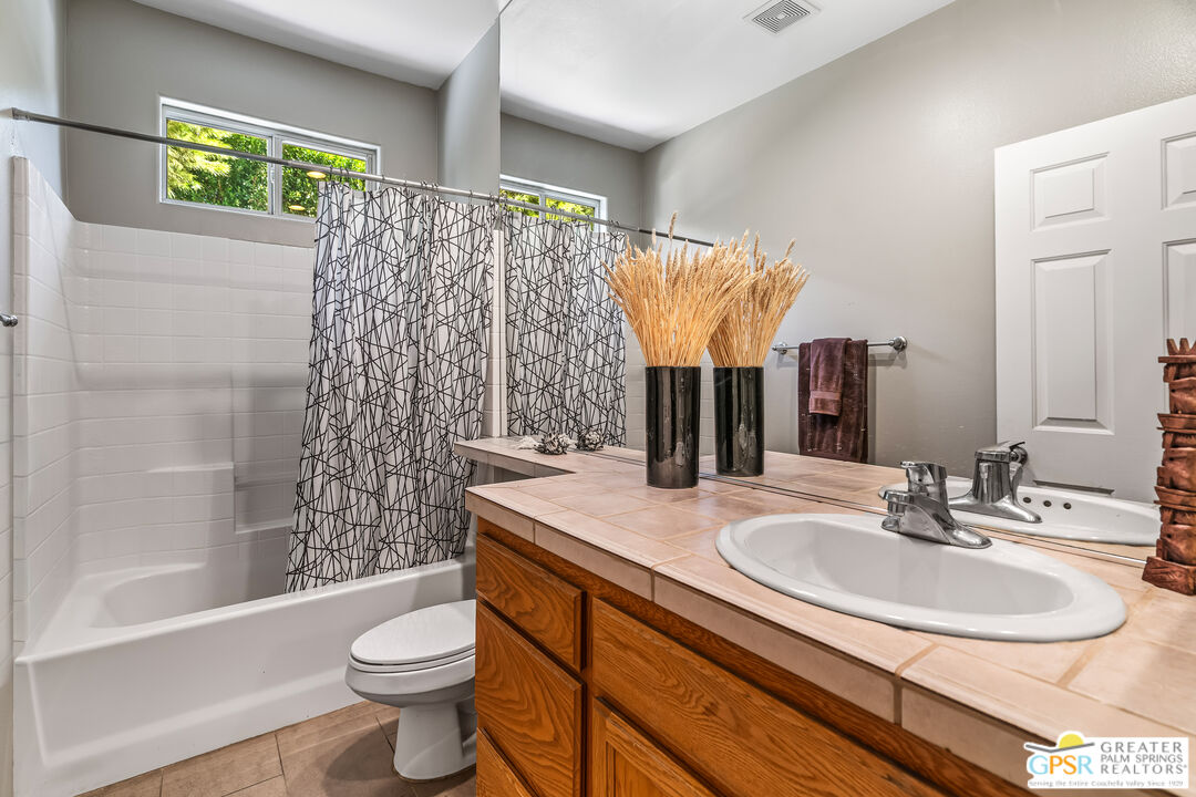 67860 Ontina Road Cathedral City, CA 92234 - Photo 31 of 48 a bathroom with a sink toilet and shower