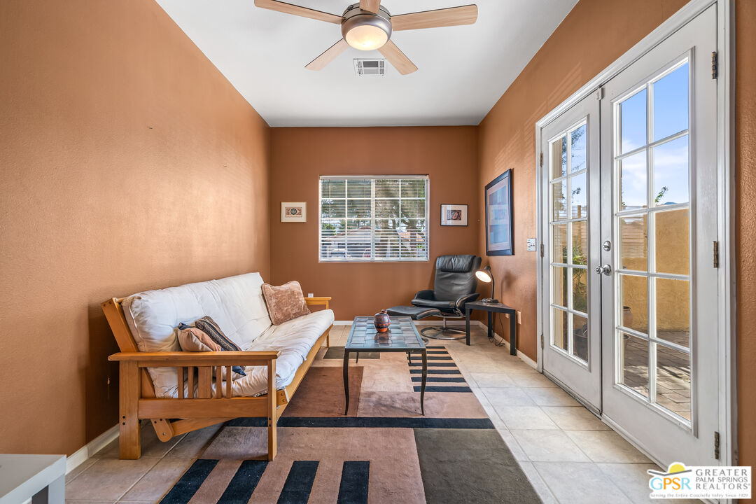 67860 Ontina Road Cathedral City, CA 92234 - Photo 34 of 48 a living room with furniture a rug and a chandelier