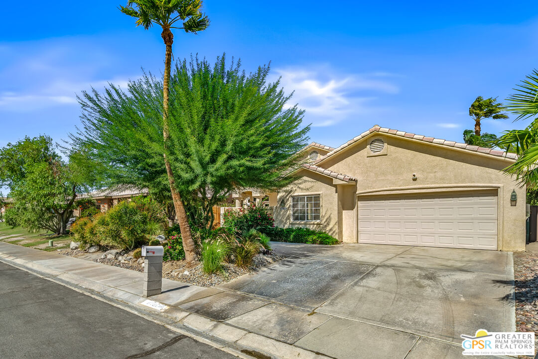 67860 Ontina Road Cathedral City, CA 92234 - Photo 41 of 48 a view of a house with a small yard and potted plants