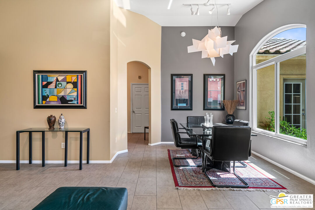 67860 Ontina Road Cathedral City, CA 92234 - Photo 8 of 48 a living room with furniture a chandelier and a dining table