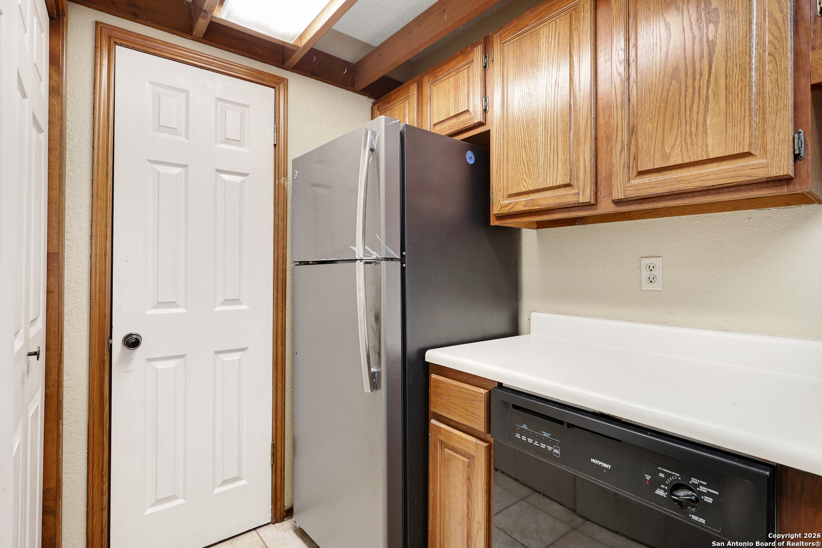 8633 Datapoint Drive, Unit 224 San Antonio, TX 78229 - Photo 12 of 27 a view of cabinets with refrigerator