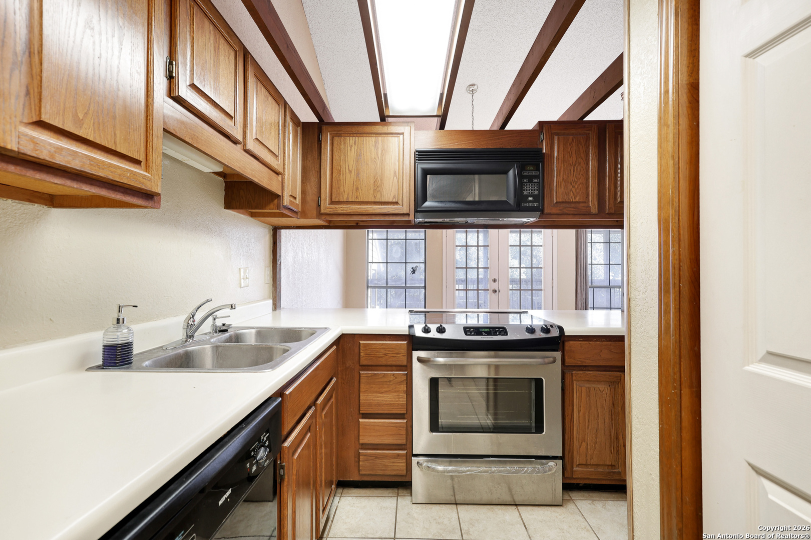 8633 Datapoint Drive, Unit 224 San Antonio, TX 78229 - Photo 13 of 27 a kitchen with stainless steel appliances granite countertop a sink and a stove