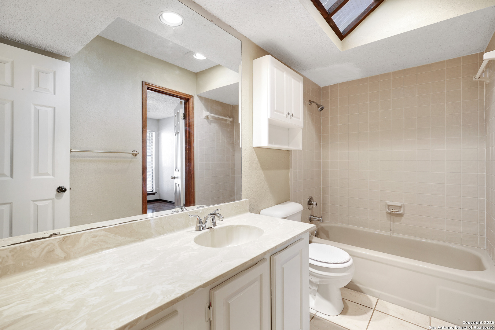 8633 Datapoint Drive, Unit 224 San Antonio, TX 78229 - Photo 17 of 27 a bathroom with a granite countertop sink a toilet and shower
