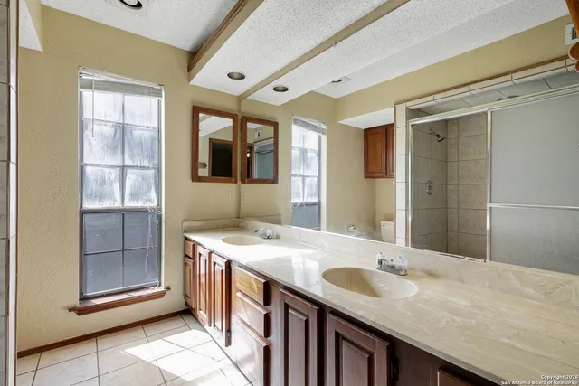 a bathroom with a granite countertop sink and mirror