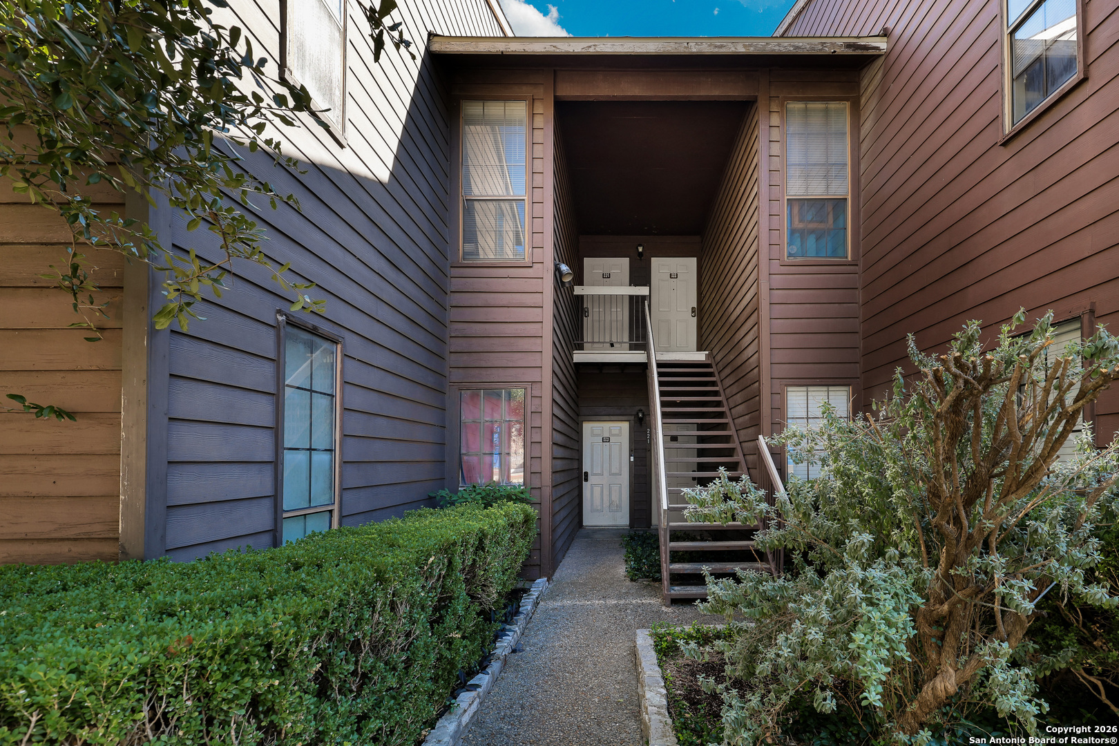 8633 Datapoint Drive, Unit 224 San Antonio, TX 78229 - Photo 2 of 27 a front view of a house with a yard