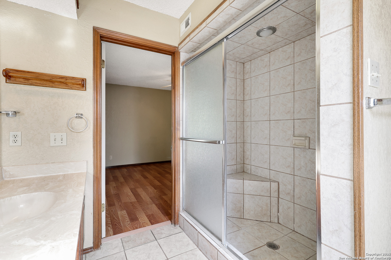 8633 Datapoint Drive, Unit 224 San Antonio, TX 78229 - Photo 21 of 27 a bathroom with a glass shower door