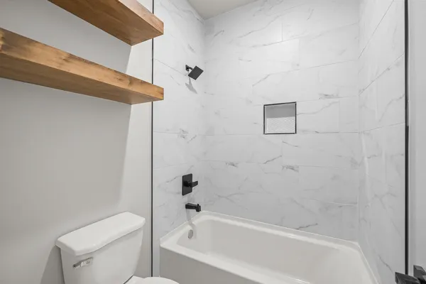 a bathroom with a bathtub and a toilet