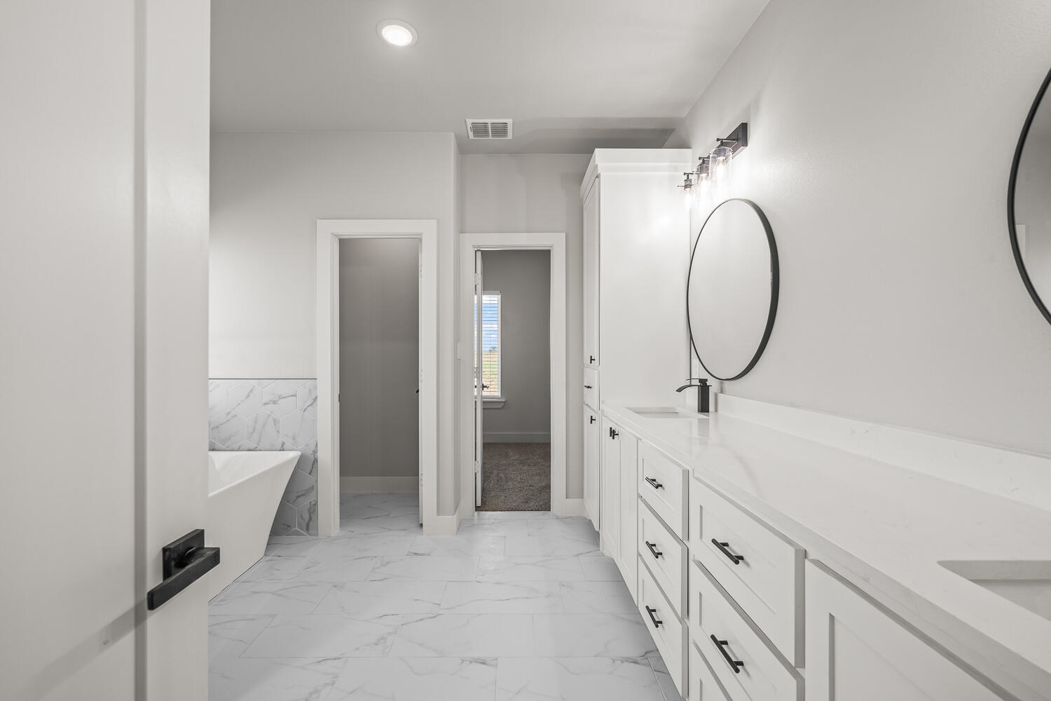 17414 C R 3100 Slaton, TX 79364 - Photo 18 of 46 a spacious bathroom with a double vanity sink and a mirror