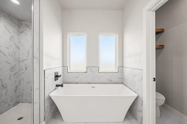 a bathroom with a bathtub and shower