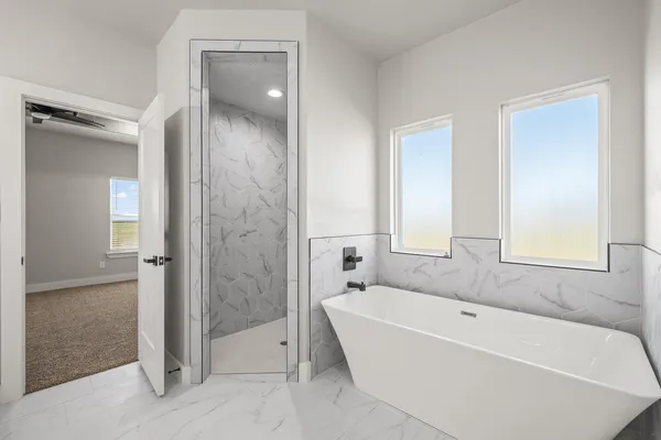 a bathroom with a double vanity sink mirror and bathtub