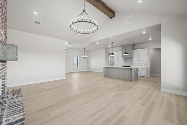 a view of an empty room with a fireplace and a window