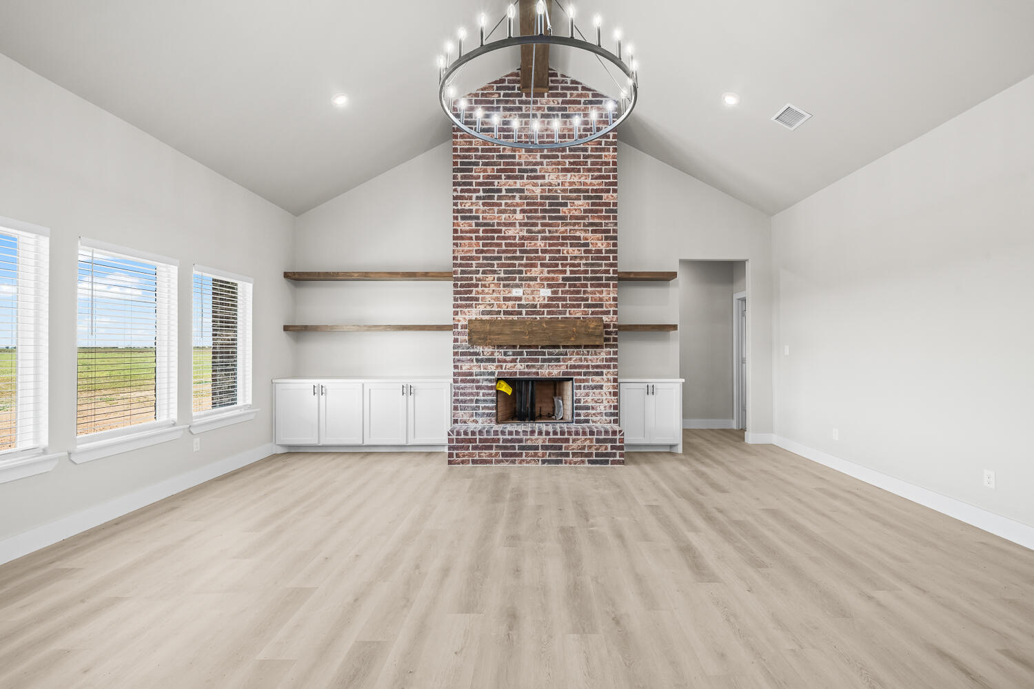 17414 C R 3100 Slaton, TX 79364 - Photo 29 of 46 a view of an empty room with a fireplace and a window