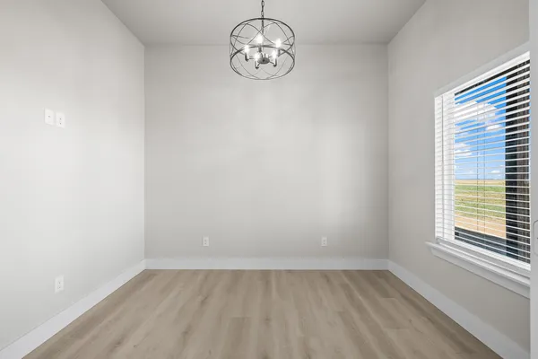 a view of a kitchen with refrigerator and white cabinets