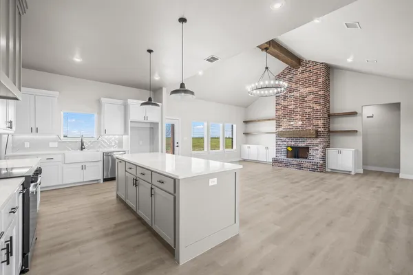 a kitchen with a sink stove and cabinets