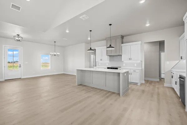 a kitchen with stainless steel appliances granite countertop a sink a oven and a wooden floors