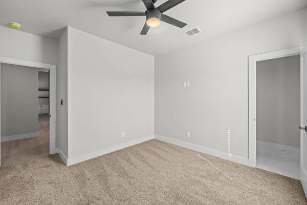 an empty room with closet and windows