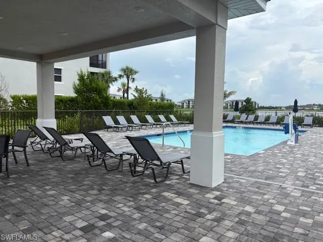 a view of a patio with table and chairs