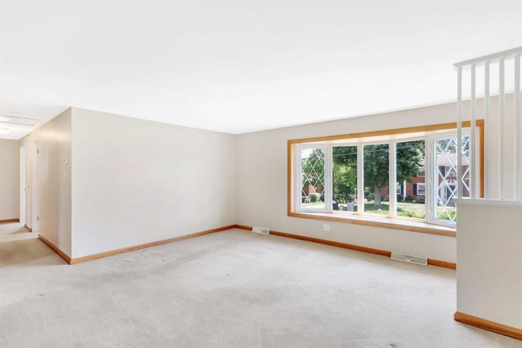 604 Dressel Road Allison Park, PA 15101 - Photo 3 of 25 The spacious living room features a large bay window with a window seat. Hard wood floors can be found under all carpeting on the main floor.