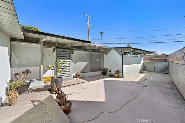 a view of a patio with table and chairs under an umbrella