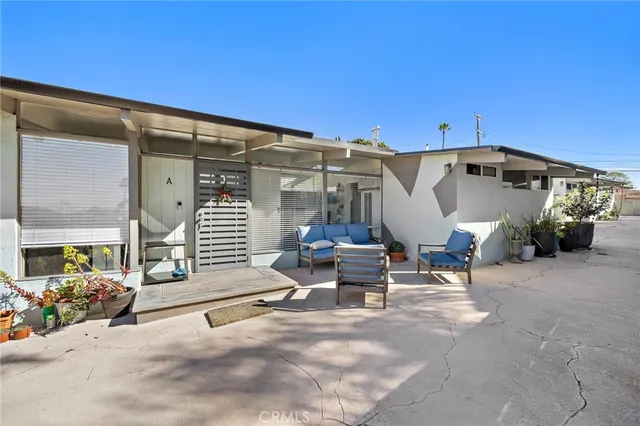 a view of a patio with table and chairs and potted plants