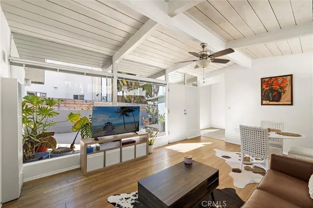 a living room with dining room and kitchen view
