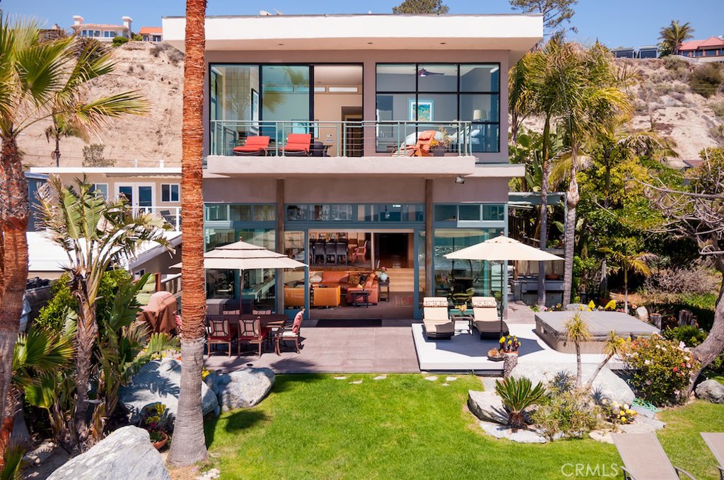 35121 Beach Road Dana Point, CA 92624 - Photo 1 of 46 a view of the patio with dining table and chairs under an umbrella