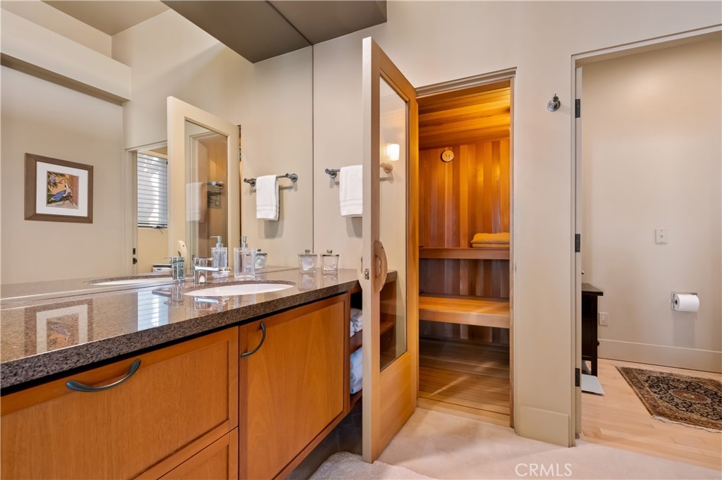 35121 Beach Road Dana Point, CA 92624 - Photo 25 of 46 a bathroom with a double vanity sink and a mirror