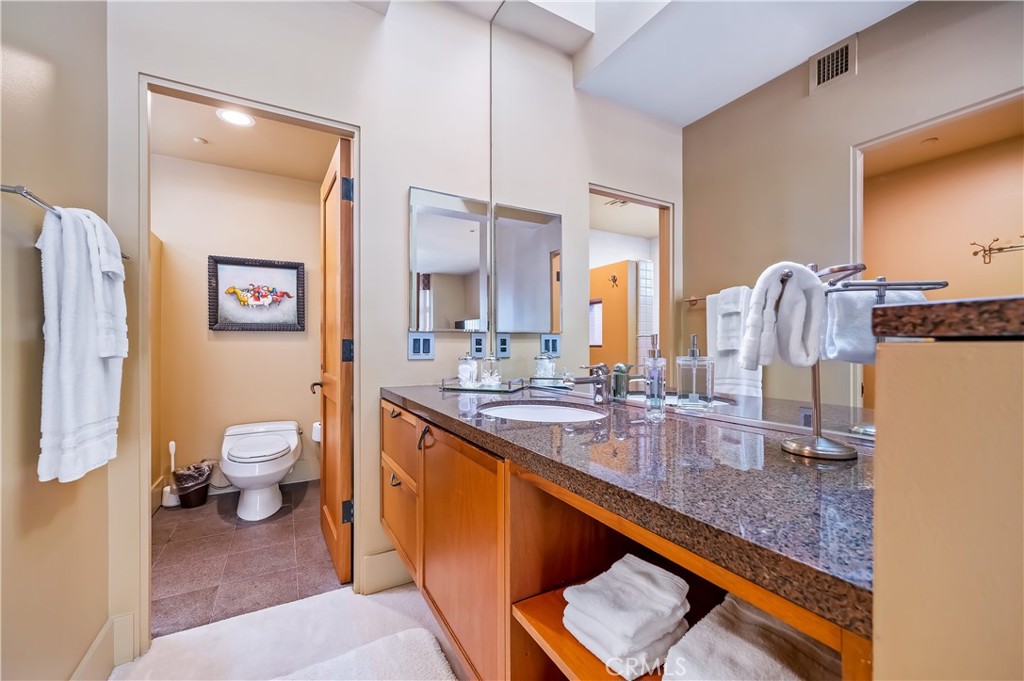 35121 Beach Road Dana Point, CA 92624 - Photo 39 of 46 a bathroom with a granite countertop sink toilet and a mirror
